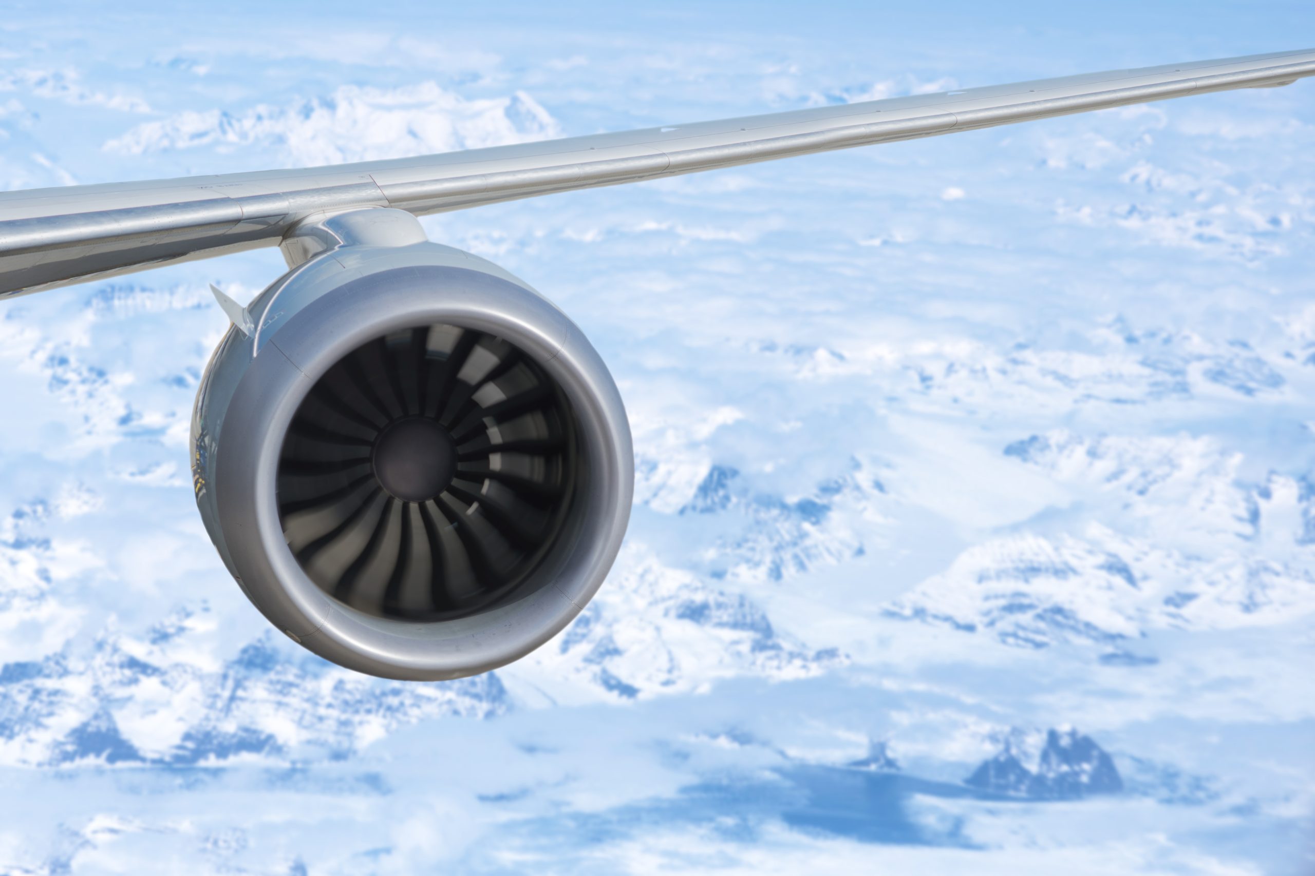 airplane engine above the Greenland with ocean and glaciers Antarctica Destination