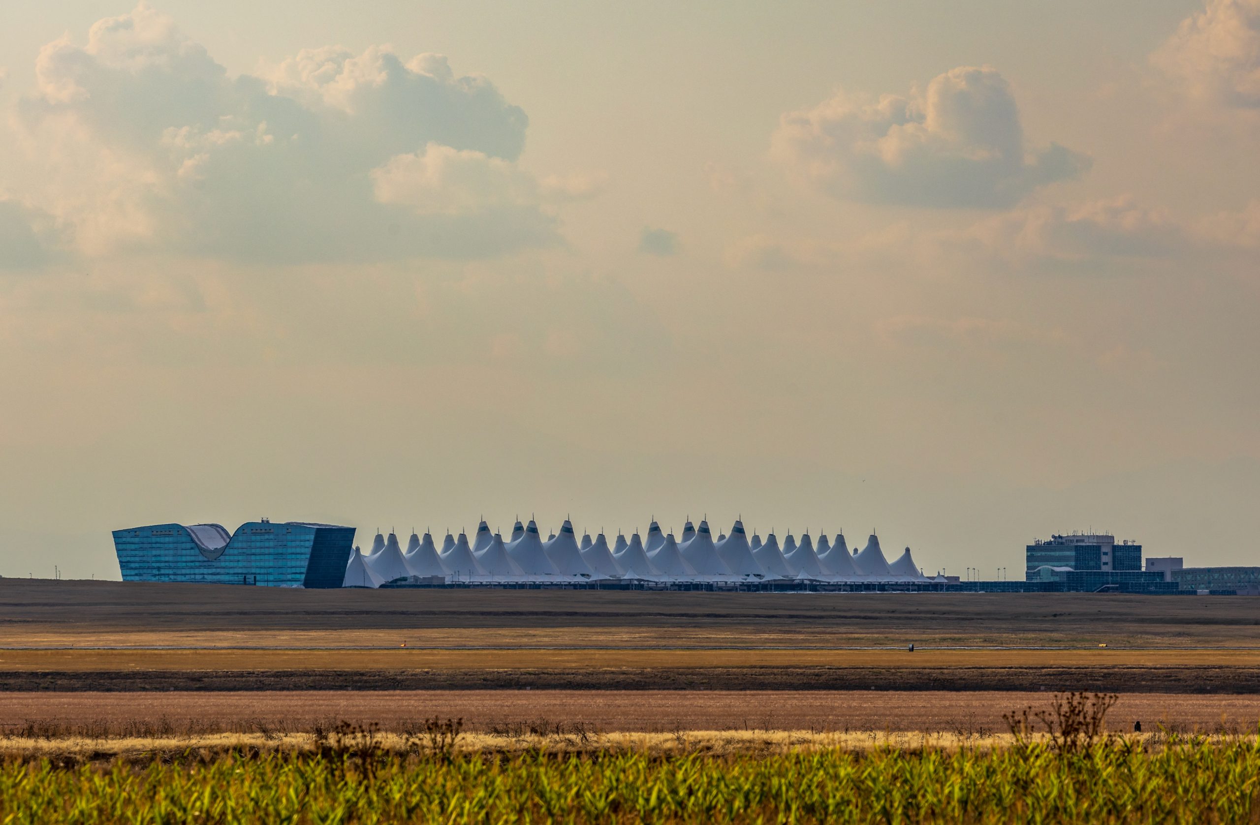 Denver International Airport in the distance against the afternoon sky Destination North America Airport